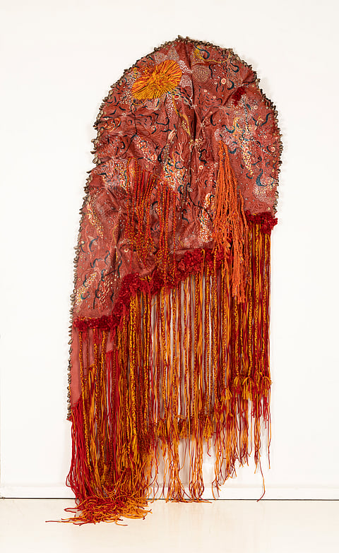 "Skin of Unfolding Desires" is made of latex rubber, acrylic ink, threads, stone eyes, cowrie shells and brass washer